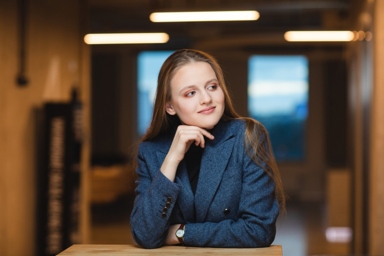 Mediacje sądowe i pozasądowe | Studia podyplomowe we Wrocławiu | Uniwersytet Dolnośląski DSW we Wrocławiu: studentka w grafitowej marynarce siedząca przy stole