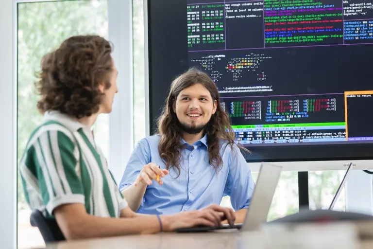 Konferencja FutureLab: Biznes, Ludzie, Kompetencje w przestrzeni jutra | Uniwersytet Dolnośląski DSW we Wrocławiu: Główna grafika: Druk 3D w przemyśle - studenci rozmawiający ze sobą na zajęciach z informatyki