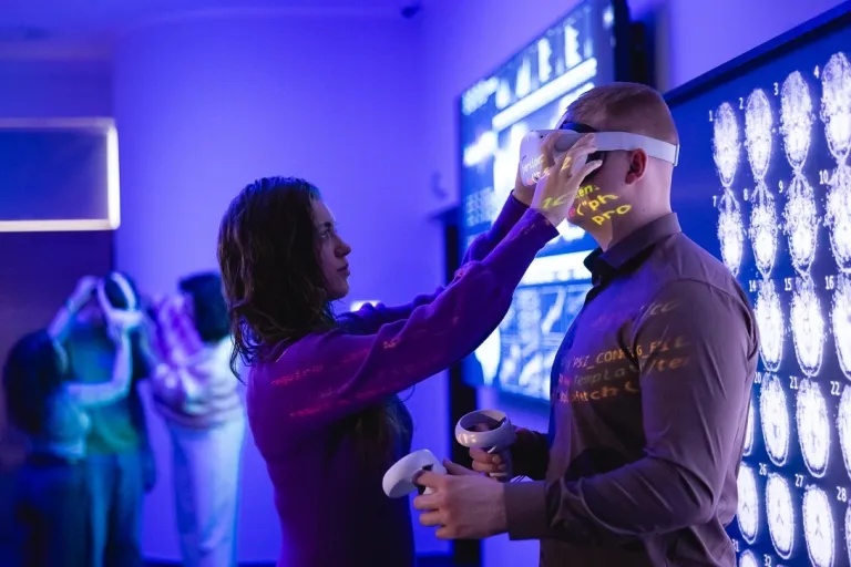 Neuroinformatyka | Studia I stopnia we Wrocławiu | Uniwersytet Dolnośląski DSW we Wrocławiu: Studentka pomaga w założeniu gogli VR